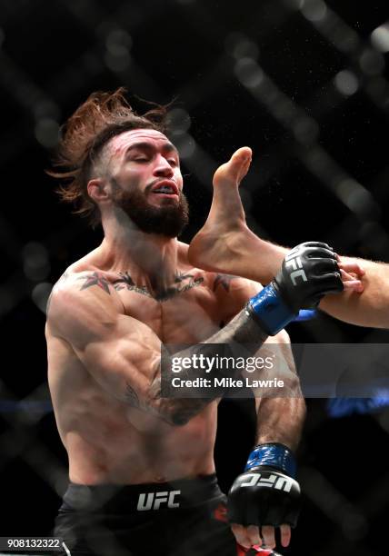 Calvin Kattar lands a kick against Shane Burgos in their Featherweight fight during UFC 220 at TD Garden on January 20, 2018 in Boston, Massachusetts.