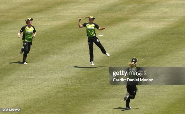 Thunder Naomi Stalenberg jumps in the air after catching out Strikers Tahlia McGrath during the Women's Big Bash League match between the Adelaide...