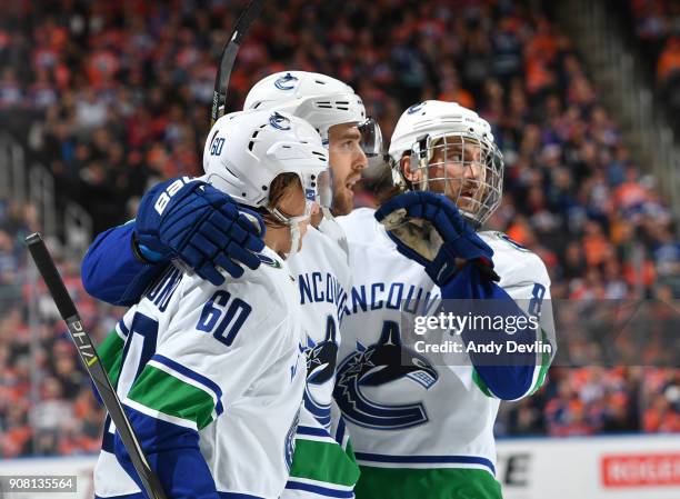 Brandon Sutter, Christopher Tanev and Markus Granlund of the Vancouver Canucks celebrate after a goal during the game against the Edmonton Oilers on...