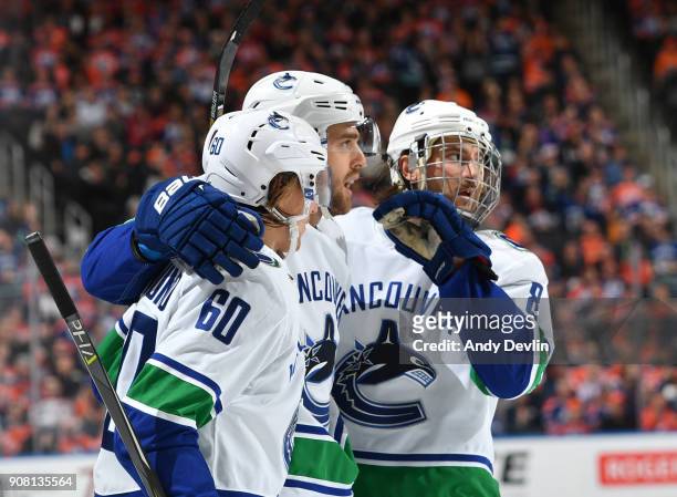 Brandon Sutter, Christopher Tanev and Markus Granlund of the Vancouver Canucks celebrate after a goal during the game against the Edmonton Oilers on...