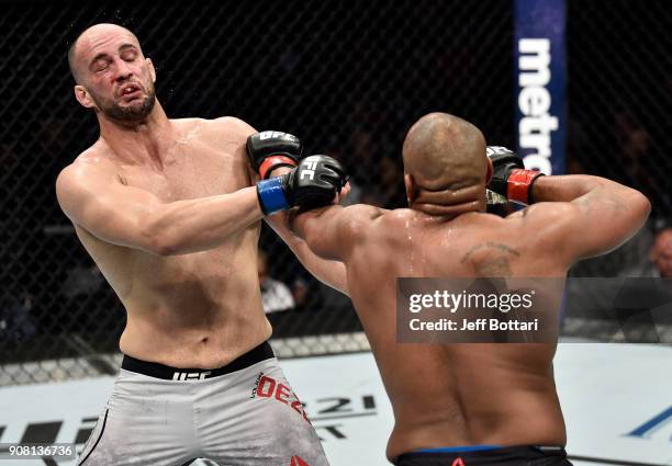 Daniel Cormier punches Volkan Oezdemir of Switzerland in their light heavyweight championship bout during the UFC 220 event at TD Garden on January...