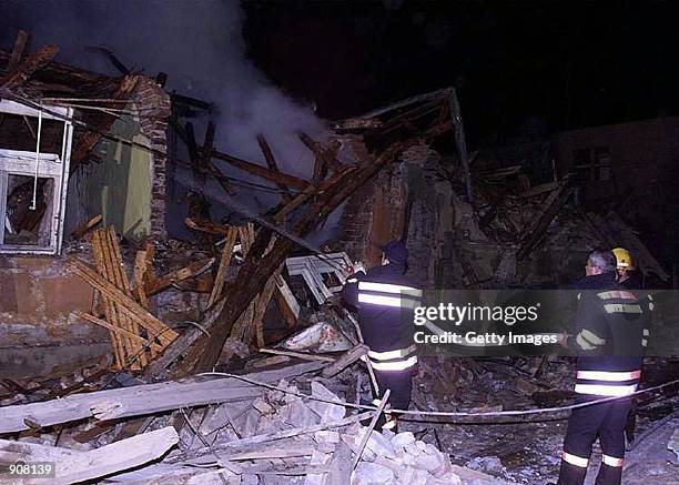 Serbian firefighters hose down the rubble of a house with water on Tuesday, April 6, 1999 in Aleksinac, 200 kilometers south of Belgrade, Yugoslavia....