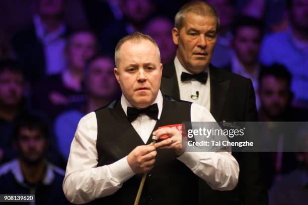 John Higgins of Scotland reacts during the semifinal match against Mark Allen of Northern Ireland on day seven of The Dafabet Masters at Alexandra...