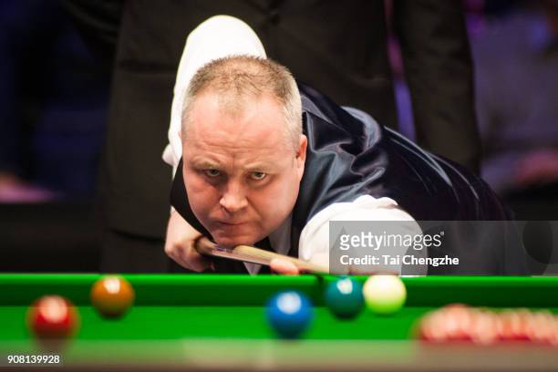 John Higgins of Scotland plays a shot during the semifinal match against Mark Allen of Northern Ireland on day seven of The Dafabet Masters at...