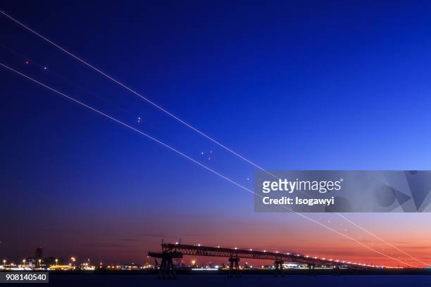 light trails in twilight sky - isogawyi stockfoto's en -beelden