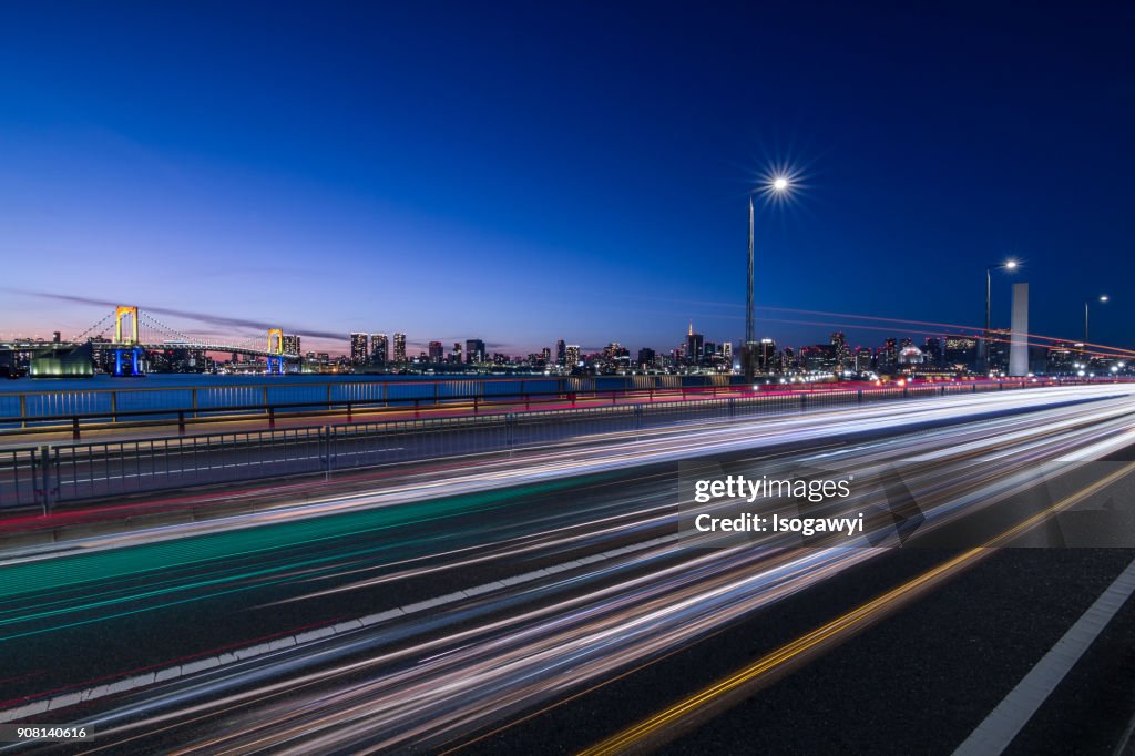 Traffic Light Trails And Tokyo City Skyline At Twilight