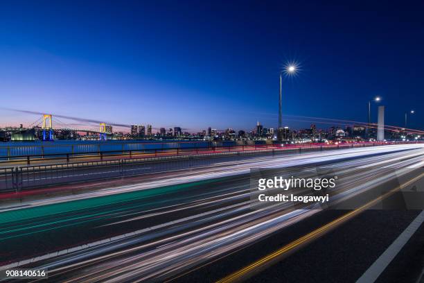 traffic light trails and tokyo city skyline at twilight - isogawyi stock pictures, royalty-free photos & images