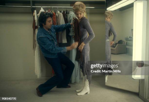 American actress Barbara Sigel looks at clothing in the dressing room on the Universal Studios lot circa November, 1970 in Universal City, California.