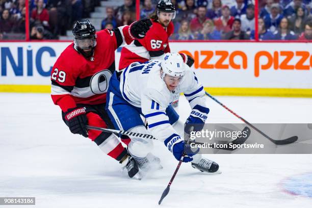 Toronto Maple Leafs Left Wing Zach Hyman turns to chase a loose puck with Ottawa Senators Defenceman Johnny Oduya giving chase during first period...