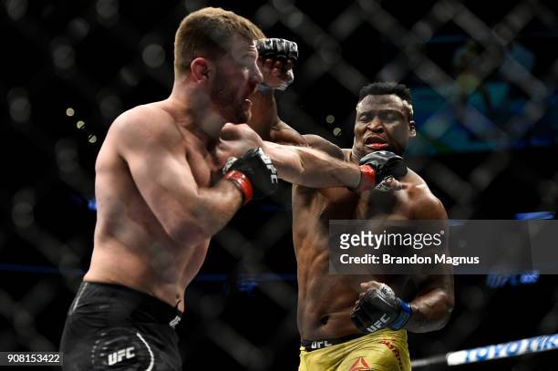 Stipe Miocic punches Francis Ngannou of Cameroon in their heavyweight championship bout during the UFC 220 event at TD Garden on January 20, 2018 in...