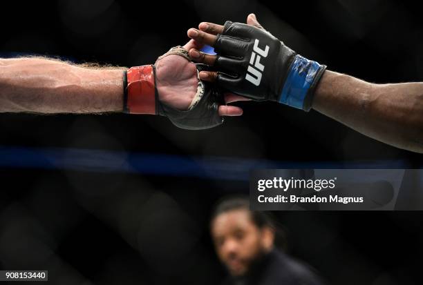 Francis Ngannou of Cameroon and Stipe Miocic touch gloves in their heavyweight championship bout during the UFC 220 event at TD Garden on January 20,...