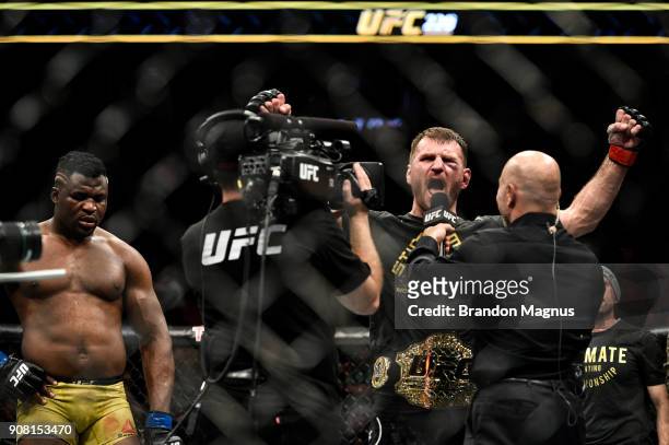 Stipe Miocic celebrates his victory over Francis Ngannou of Cameroon in their heavyweight championship bout during the UFC 220 event at TD Garden on...