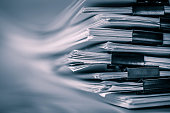 the extreamely close up  report paper stacking of office working document , retro color tone