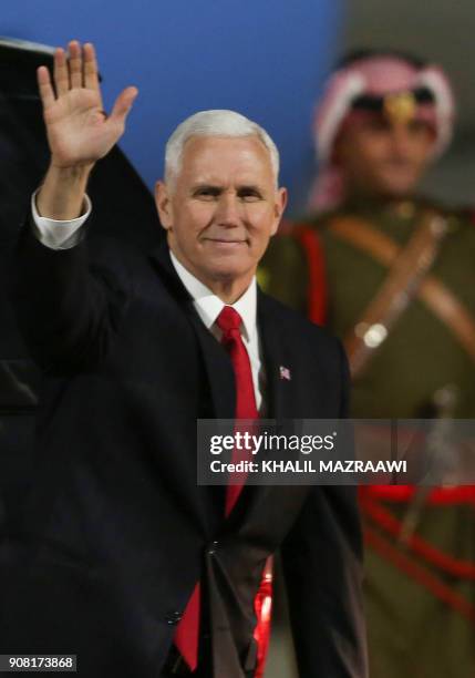 Vice President Mike Pence waves after leaving Air Force Two upon his arrival in the Jordanian capital Amman, late on January 20, 2018. / AFP PHOTO /...