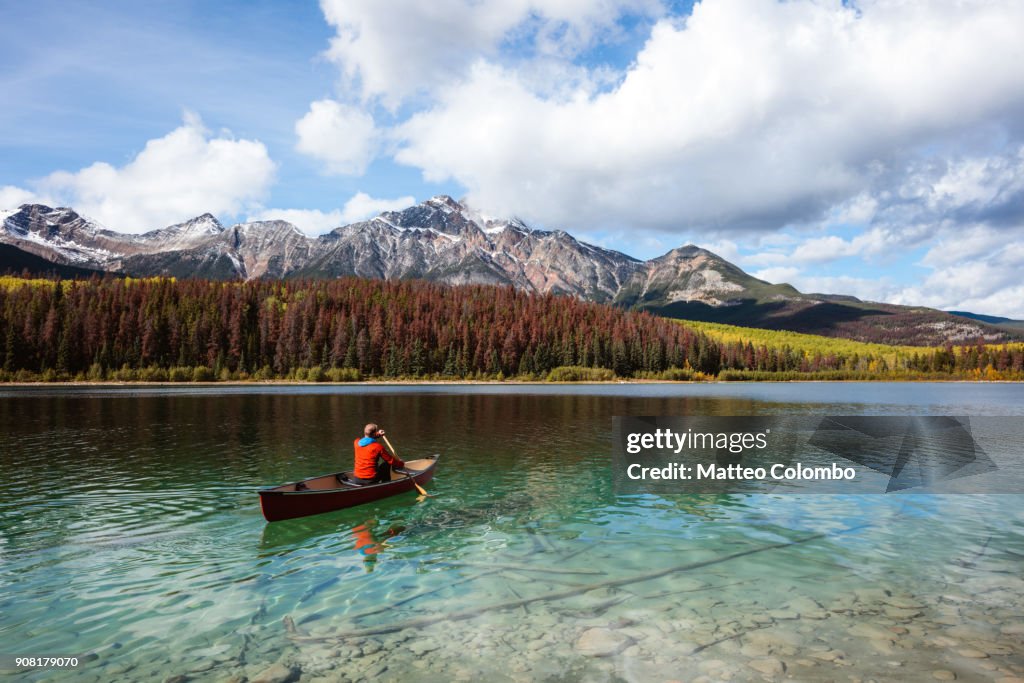 Man canoeing on lake, Jasper National Park, Canada