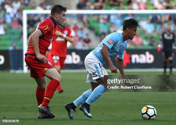 Daniel Arzani of the City is challenged by Ryan Strain of Adelaide United during the round 17 A-League match between Melbourne City and Adelaide...