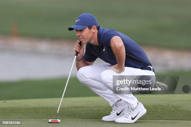 Rory McIlroy of Northern Ireland lines up a putt on the first green during the final round of the Abu Dhabi HSBC Golf Championship at Abu Dhabi Golf...