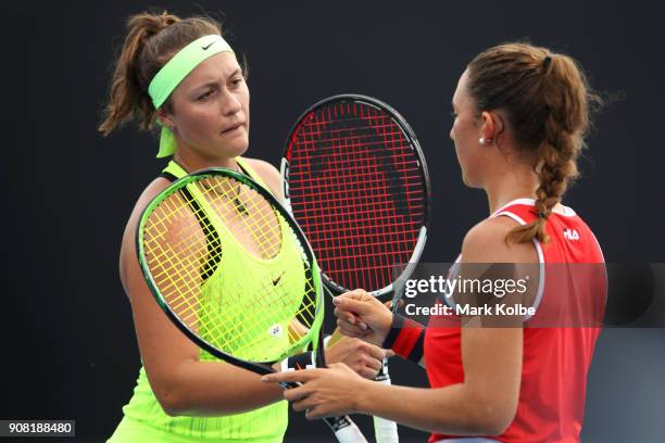 Gabriella Da Silva Fick of Australia and Ivana Popovic of Australia talk tactics in their doubles match against Ali Collins of Great Britain and...