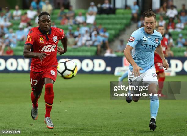 Mark Ochieng of Adelaide United and Scott Jamieson of the City chase the ball during the round 17 A-League match between Melbourne City and Adelaide...