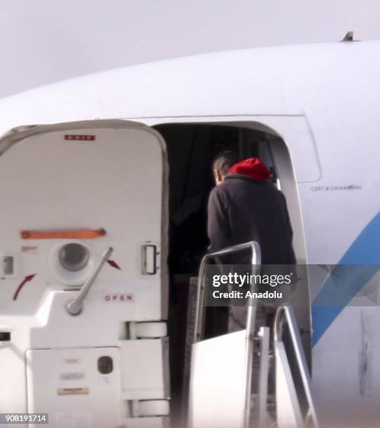 Chained illegal immigrants are seen as they get boarded onto a plane for deportation at Gary/Chicago International Airport in Chicago, United States...