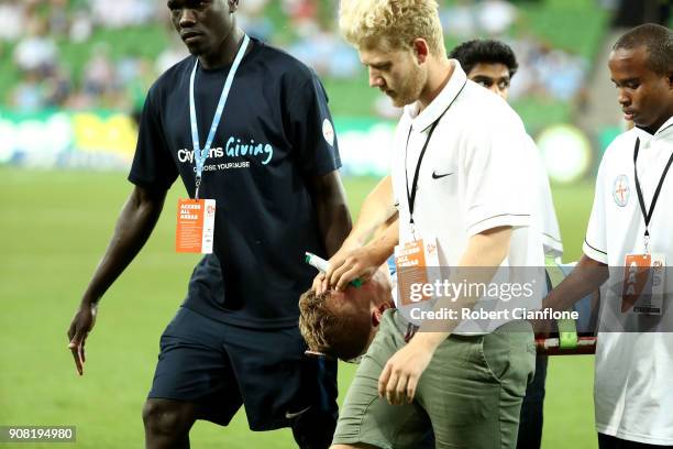 Nathaniel Atkinson of the City is stretchered off with an injury during the round 17 A-League match between Melbourne City and Adelaide United at...