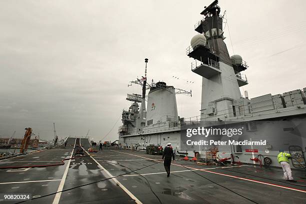 An officer crosses the empty flight deck of HMS Ark Royal on September 15, 2009 in Portsmouth, England. The Royal Navy's flag ship HMS Ark Royal,...