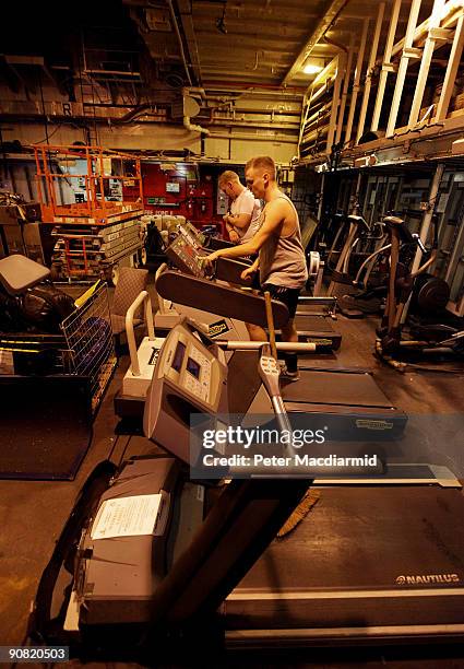 Ark Royal crew use gymnasium equipment on the hangar deck on September 15, 2009 in Portsmouth, England. The Royal Navy's flag ship HMS Ark Royal,...