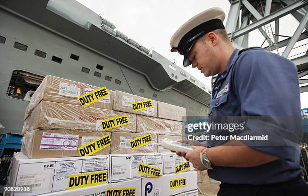 An officer checks the temperature of a delivery of frozen food on the quayside before loading onto HMS Ark Royal on September 15, 2009 in Portsmouth,...