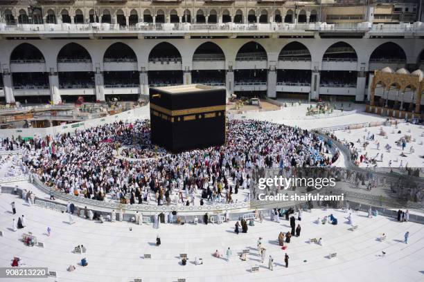 muslim pilgrims circumambulate or "tawaf" the kaabah after subuh prayer at masjidil haram, makkah, saudi arabia. - hajj stock-fotos und bilder