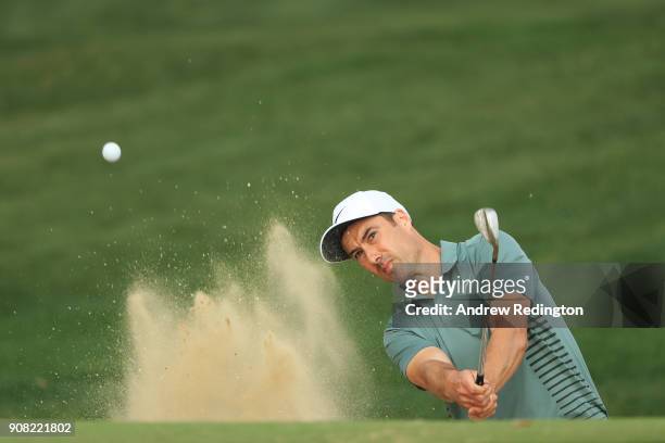 Ross Fisher of England plays his fifth shot from a bunker on the tenth hole during the final round of the Abu Dhabi HSBC Golf Championship at Abu...