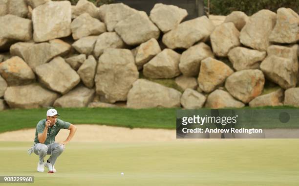 Ross Fisher of England lines up a putt on the 12th green during the final round of the Abu Dhabi HSBC Golf Championship at Abu Dhabi Golf Club on...