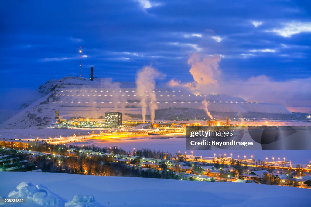 White landscape: Arctic Circle town with illuminated mountain mine on winter night