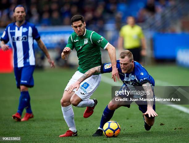 Joseba Zaldua of Club Deportivo Leganes duels for the ball with John Guidetti of Deportivo Alaves during the La Liga match between Deportivo Alaves...