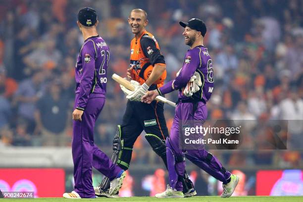 Ashton Agar of the Scorchers shares a moment with D'Arcy Short and Matthew Wade of the Hurricanes after winning the Big Bash League match between the...