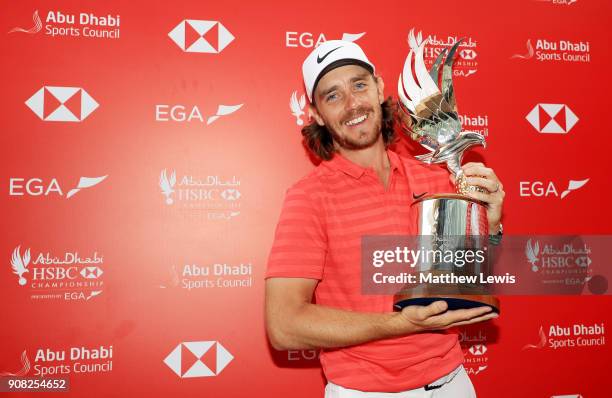 Tommy Fleetwood of England celebrates with the winner's trophy after the final round of the Abu Dhabi HSBC Golf Championship at Abu Dhabi Golf Club...