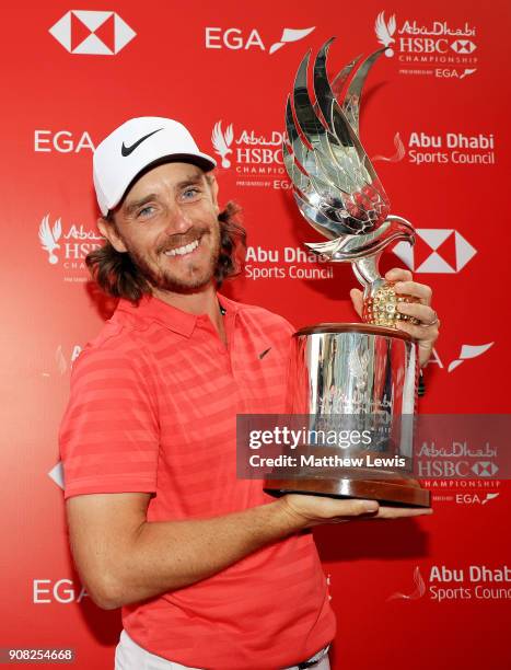 Tommy Fleetwood of England celebrates with the winner's trophy after the final round of the Abu Dhabi HSBC Golf Championship at Abu Dhabi Golf Club...