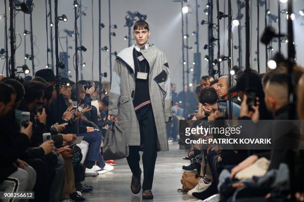 Model presents creations by Lanvin during men's Fashion Week for the Fall/Winter 2018/2019 collection in Paris on January 21, 2018. / AFP PHOTO /...