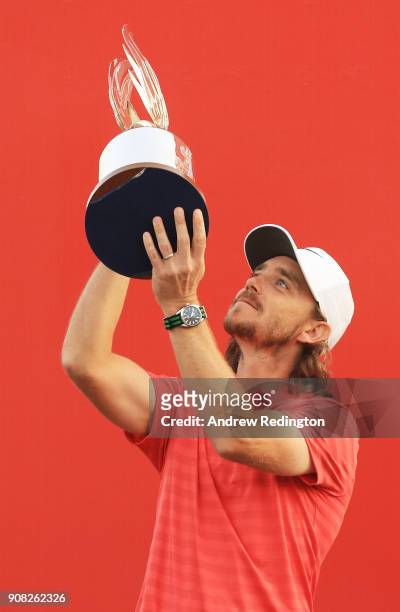 Tommy Fleetwood of England celebrates with the winner's trophy after the final round of the Abu Dhabi HSBC Golf Championship at Abu Dhabi Golf Club...