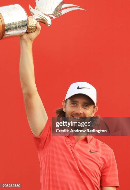 Tommy Fleetwood of England celebrates with the winner's trophy after the final round of the Abu Dhabi HSBC Golf Championship at Abu Dhabi Golf Club...