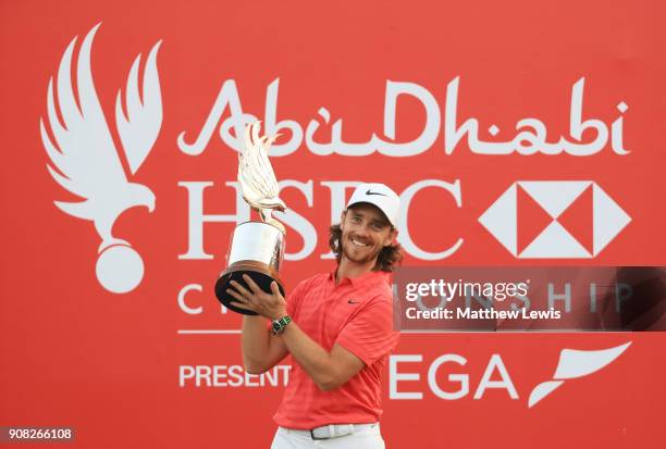 Tommy Fleetwood of England celebrates with the winner's trophy after the final round of the Abu Dhabi HSBC Golf Championship at Abu Dhabi Golf Club...