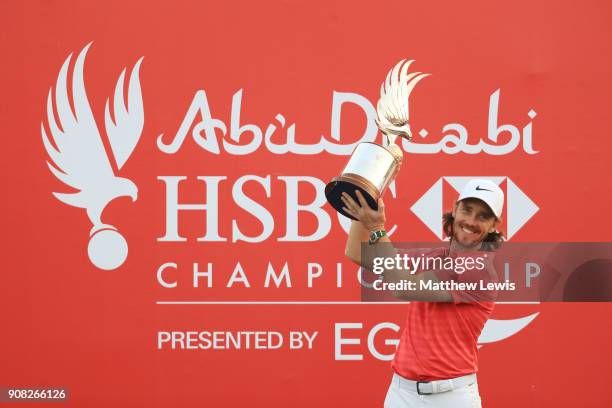 Tommy Fleetwood of England celebrates with the winner's trophy after the final round of the Abu Dhabi HSBC Golf Championship at Abu Dhabi Golf Club...