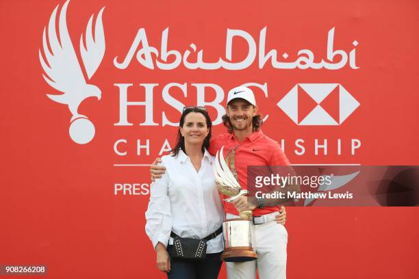 Tommy Fleetwood of England celebrates with his wife Clare Craig and the trophy after winning during the final round of the Abu Dhabi HSBC Golf...