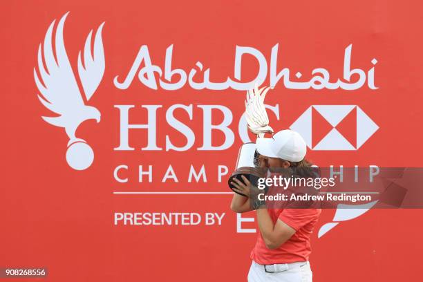 Tommy Fleetwood of England celebrates with the winner's trophy after the final round of the Abu Dhabi HSBC Golf Championship at Abu Dhabi Golf Club...