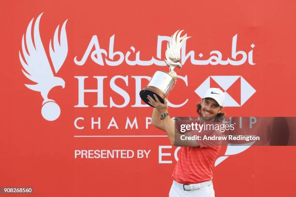 Tommy Fleetwood of England celebrates with the winner's trophy after the final round of the Abu Dhabi HSBC Golf Championship at Abu Dhabi Golf Club...