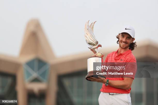 Tommy Fleetwood of England celebrates with the winner's trophy after the final round of the Abu Dhabi HSBC Golf Championship at Abu Dhabi Golf Club...