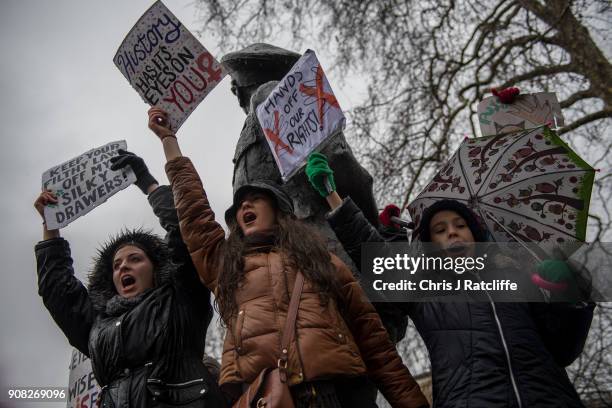 Women's rights demonstrators hold placards and chant slogans during the Time's Up rally at Richmond Terrace, opposite Downing Street on January 21,...