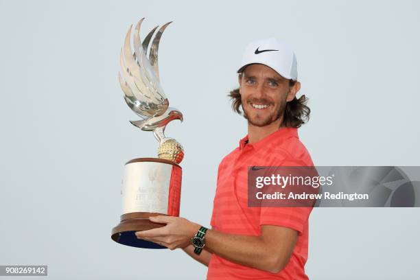 Tommy Fleetwood of England celebrates with the winner's trophy after the final round of the Abu Dhabi HSBC Golf Championship at Abu Dhabi Golf Club...