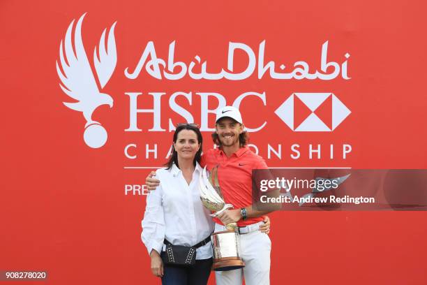 Tommy Fleetwood of England celebrates with his wife Clare Craig and the trophy after winning during the final round of the Abu Dhabi HSBC Golf...