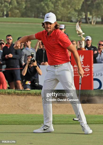 Tommy Fleetwood of England holes his final putt for birdie on the 18th green for his two shot win during the final round of the Abu Dhabi HSBC Golf...