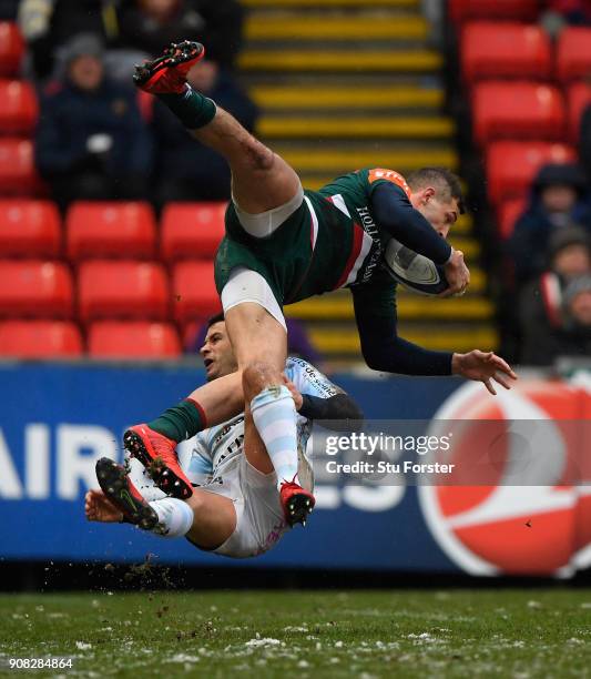 Tigers wing Jonny May is tackled in the air by Racing fullback Brice Dulin during the European Rugby Champions Cup match between Leicester Tigers and...